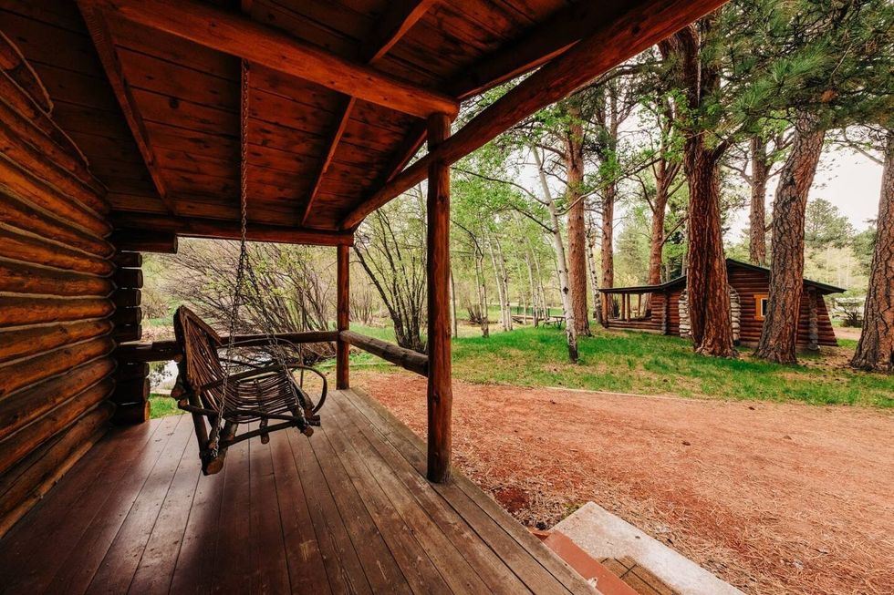 A vacant porch swing overlooks the Wyoming wild at the Wagon Box resort in Story.