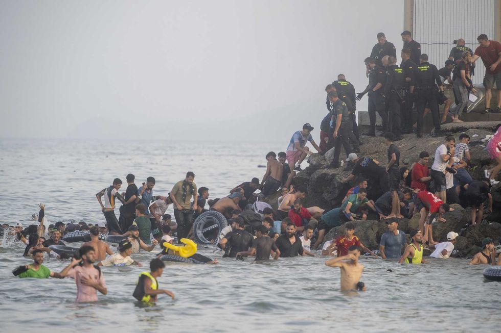 'Absolute chaos': THOUSANDS of migrants OVERRUN border into Spain from Morocco — at least 9 people dead