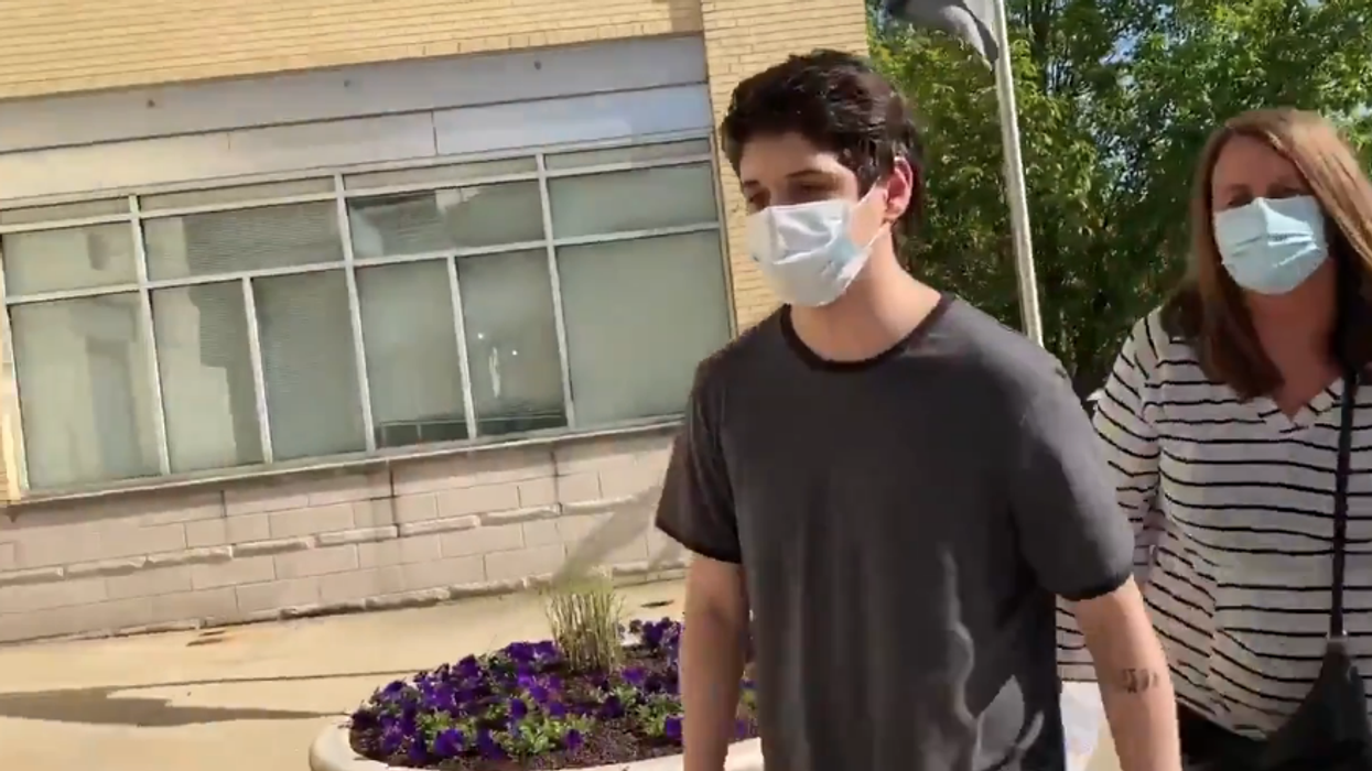 ‘Antifa kid’ who smashed a police car and incited riots is escorted into custody by his mom and dad