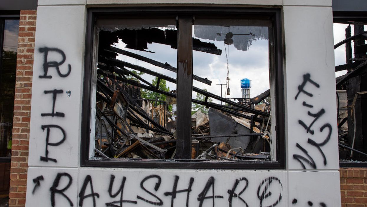 Burned building with RIP Rayshard spray-painted on it