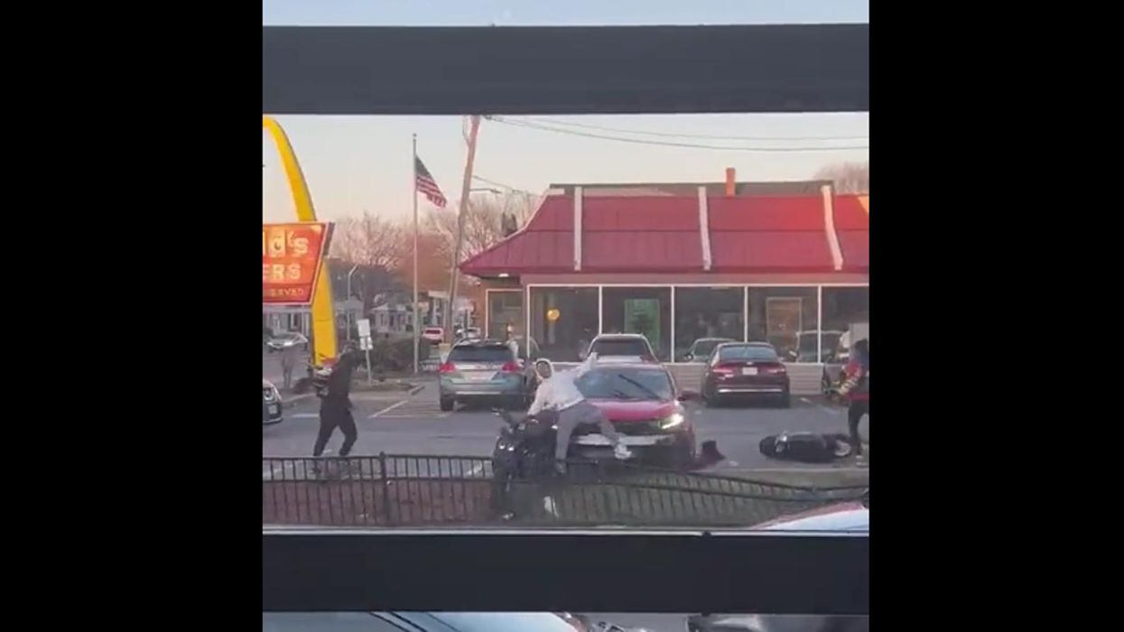 Car hits motorcyclist at McDonald's — and you have to see the insane brawl it sparks to believe it
