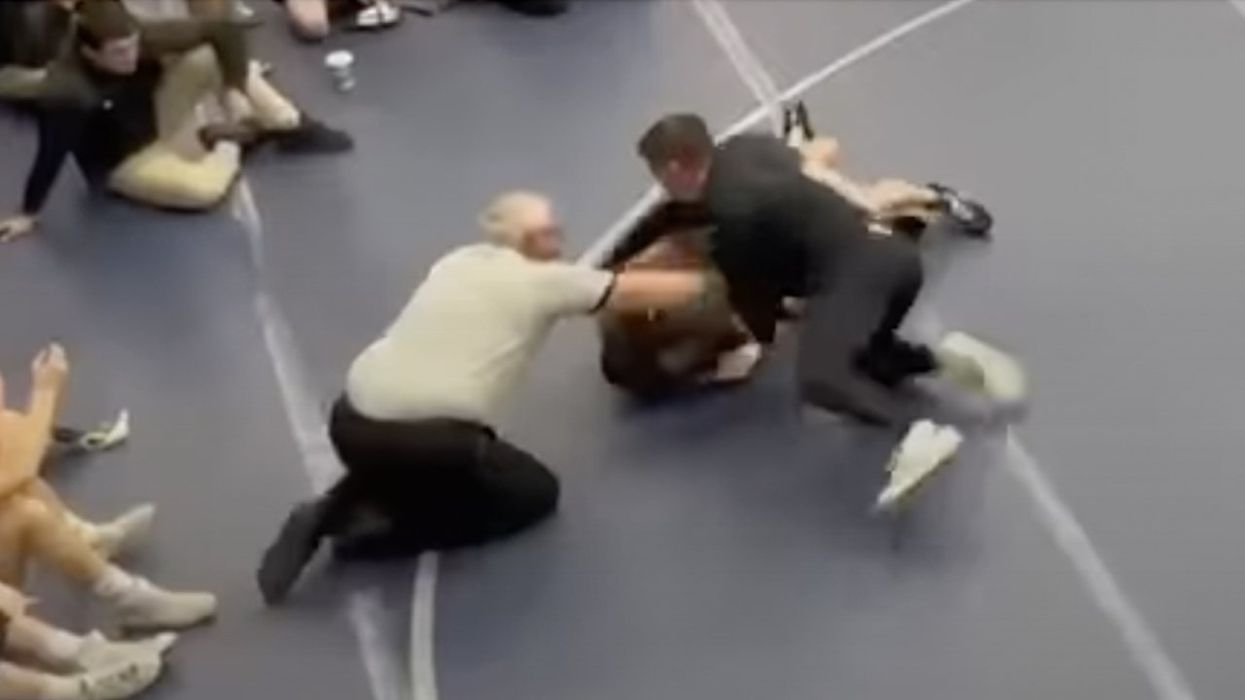 Coach hits wrestler on mat, says he was protecting son — the other wrestler — from getting choked. Now coach banned for life.