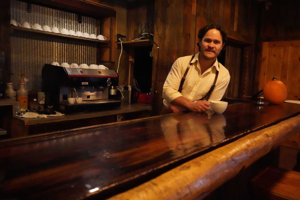 Combat veteran and real estate investor Paul McNiel tends bar at the Wagon Box in Story, Wyoming.