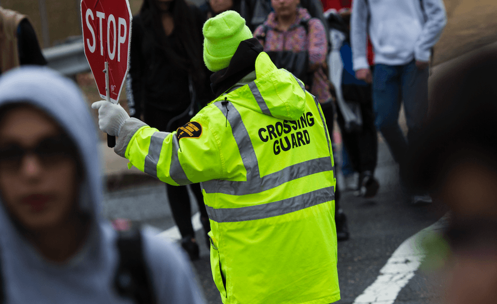 'Disgusting': Thug caught on video punching female crossing guard in face, knocking her out as elementary schoolers watch