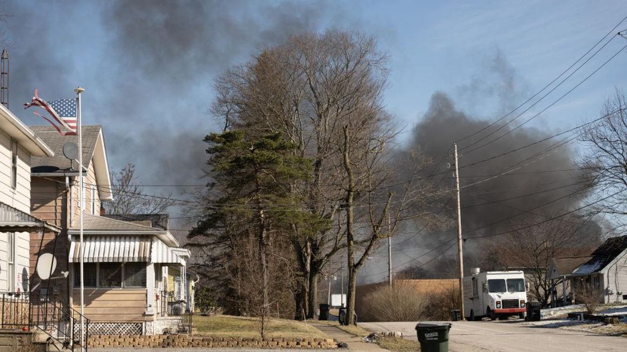 Evacuation area extended: Black smoke billows as crews release toxic chemicals from derailed tankers in Ohio