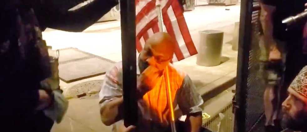 EXCLUSIVE VIDEOS: Man With American Flag Kneels In Front Of Angry Portland Rioters, Urges Them To Stop Destruction