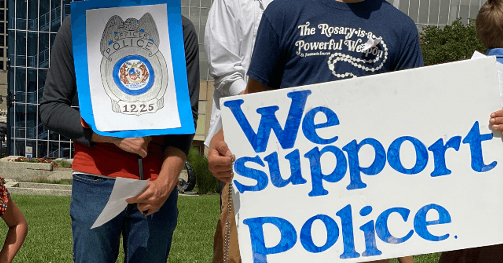 Community Comes Together to Clean Up Statue of Fallen Officer