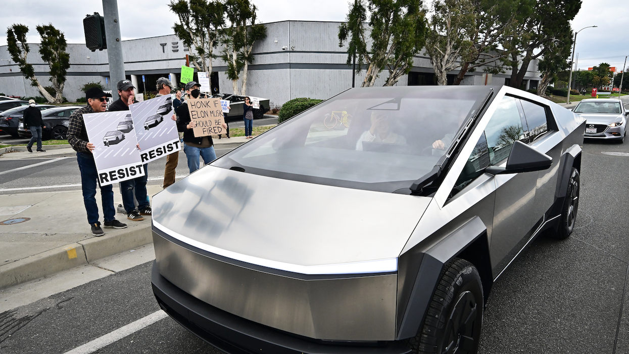 Female Tesla driver, 61, says male motorist repeatedly punched her after cutting her off, boxing her in on busy road