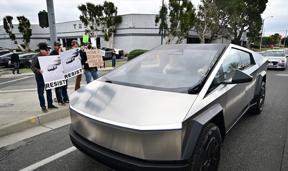 Female Tesla driver, 61, says male motorist repeatedly punched her after cutting her off, boxing her in on busy road