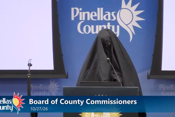 Female wearing Muslim burqa stands at mic during Florida public meeting, reports say. What she does next gets her kicked out.