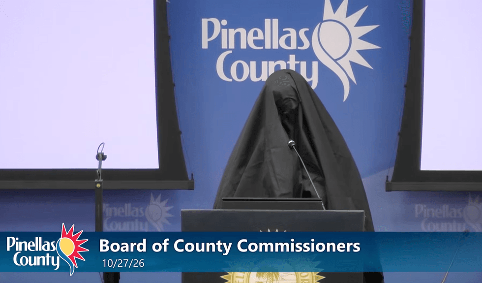 Female wearing Muslim burqa stands at mic during Florida public meeting, reports say. What she does next gets her kicked out.