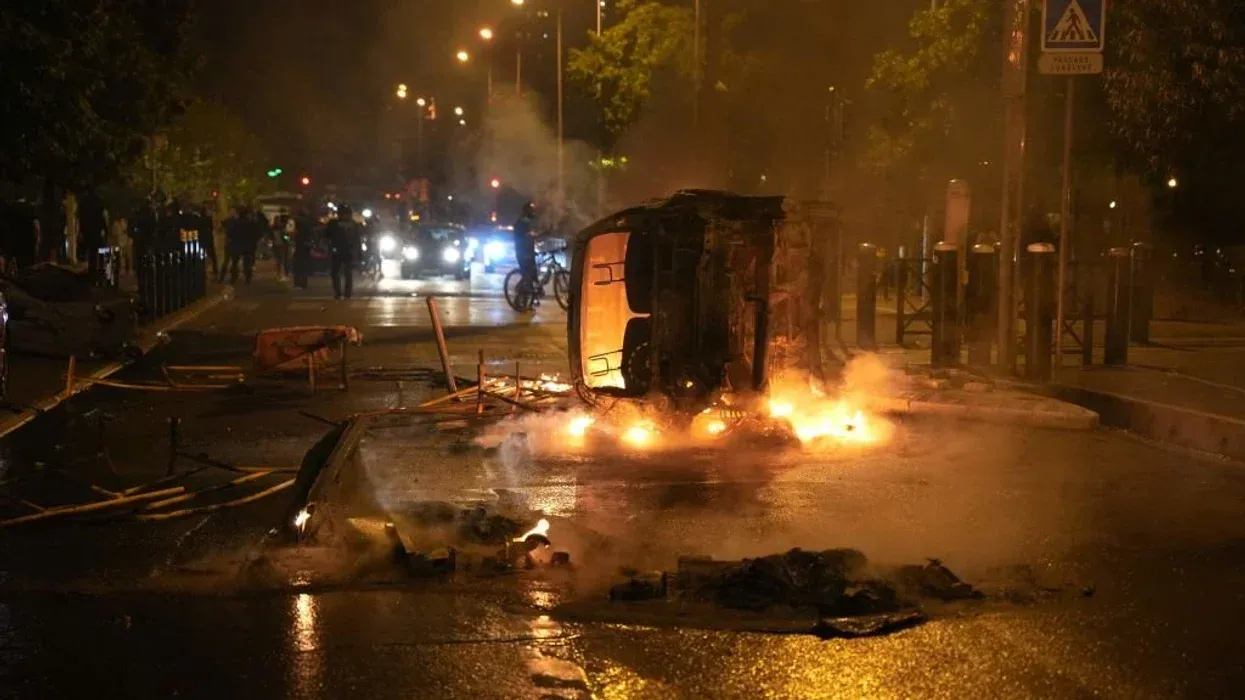 French race rioters ram burning car into conservative mayor's house where his wife and young daughters slept as part of 'cowardly assassination attempt'