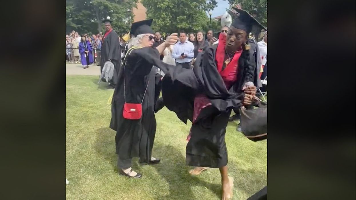 Graduate wrestles mic from apparent school official, declares to stunned crowd, 'You didn't let me get my moment ... today it's gonna be all about me!'
