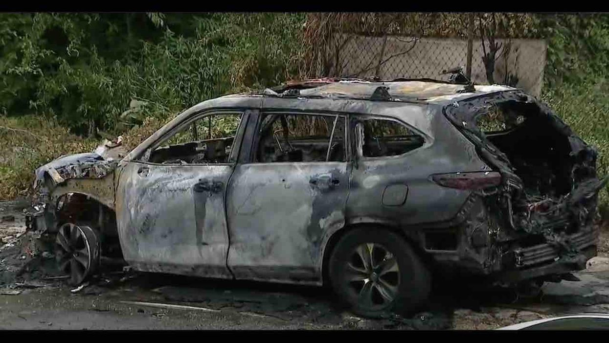 Gun-toting crook carjacks Philly cop; off-duty officer shoots 7 times as SUV speeds away. Later, cop's vehicle found on fire; shot 15-year-old reportedly is suspect.