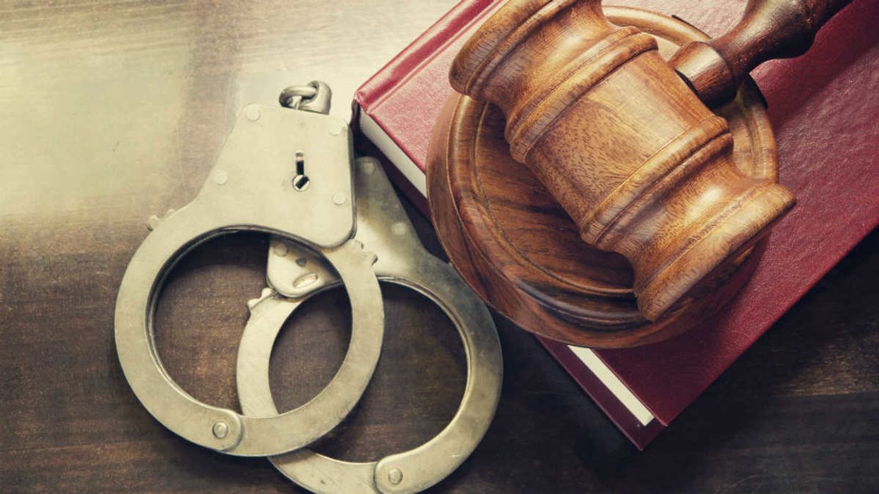 Handcuffs, gavel, law book