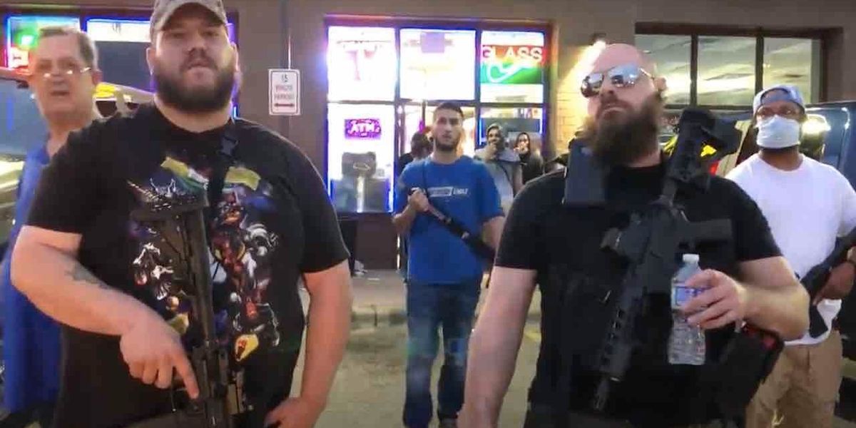 Heavily armed rednecks' who support protesters stand in front of ...