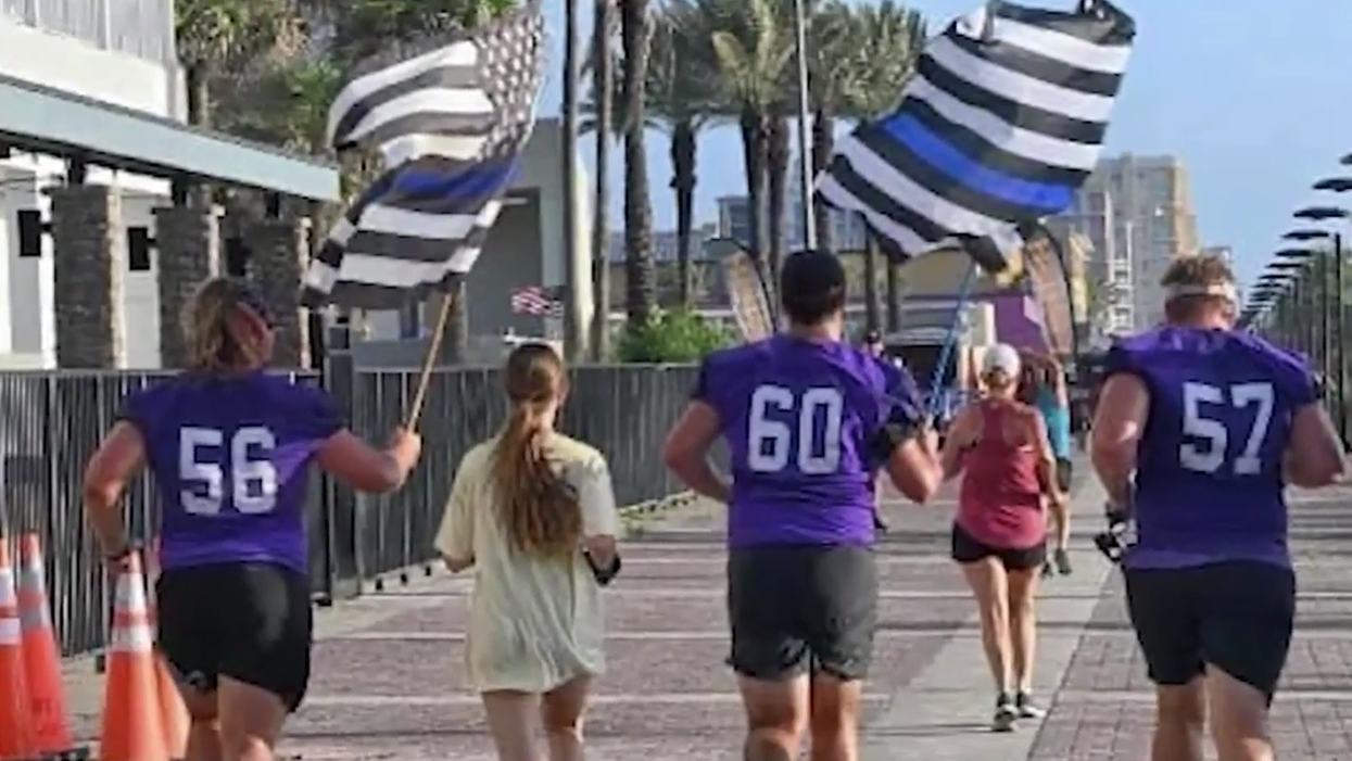 High school football team banned from honoring player's late father, a police officer, with Thin Blue Line flag after accusation of racism