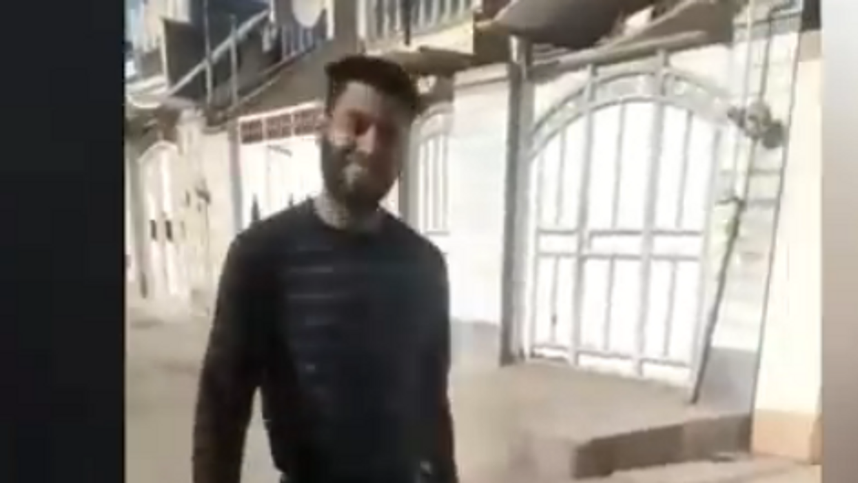 Horrifying video shows Iranian man parading severed head of murdered wife through the streets with a smile on his face
