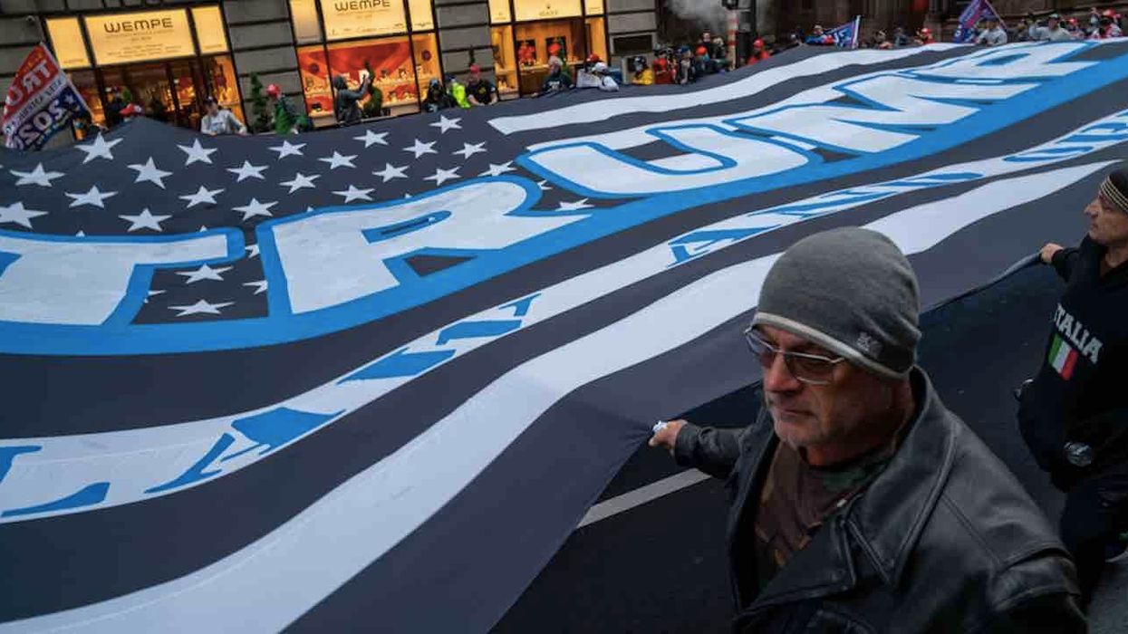 Huge Trump flag unfurled over Black Lives Matter mural on NYC street in front of Trump Tower and paraded around city