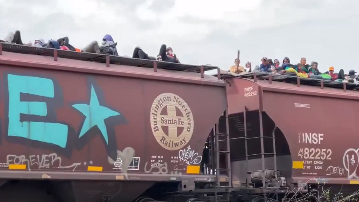 Hundreds of migrants ride on top of train in Mexico headed for US border
