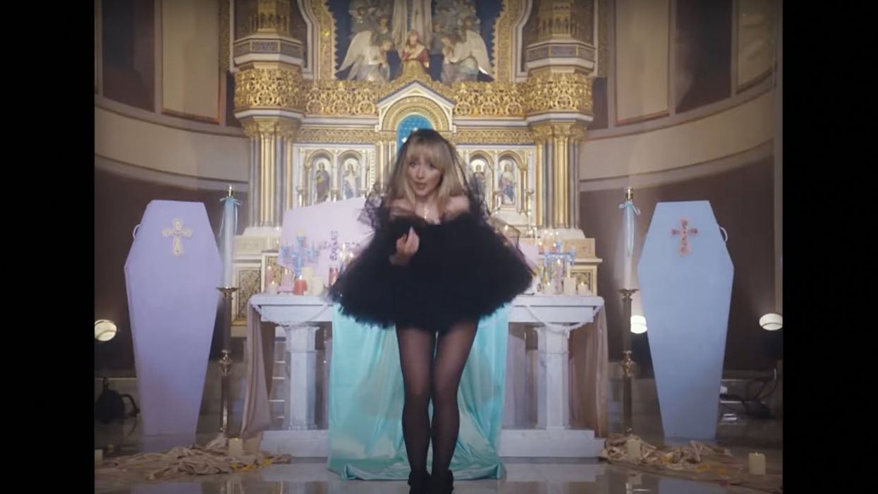 'Jesus was a carpenter': Pop singer unrepentant over racy video shot in Catholic church. Priest who OK'd shoot is punished.