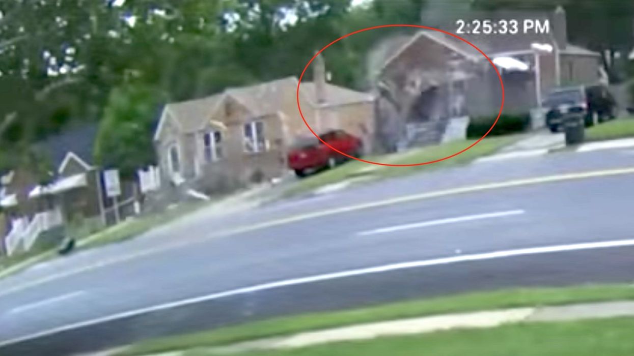 Unbelievable video captures the moment a car flies through the air and crashes into the side of a home, missing a child 'by inches'