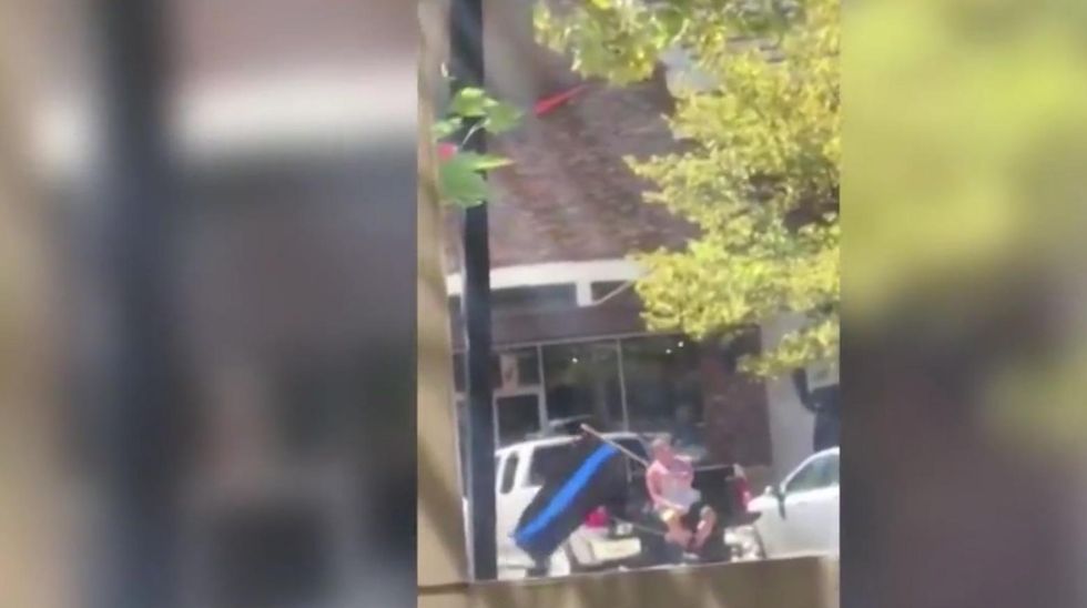 Man waves pro-police flag outside Arkansas Nike store. They respond by calling law enforcement.