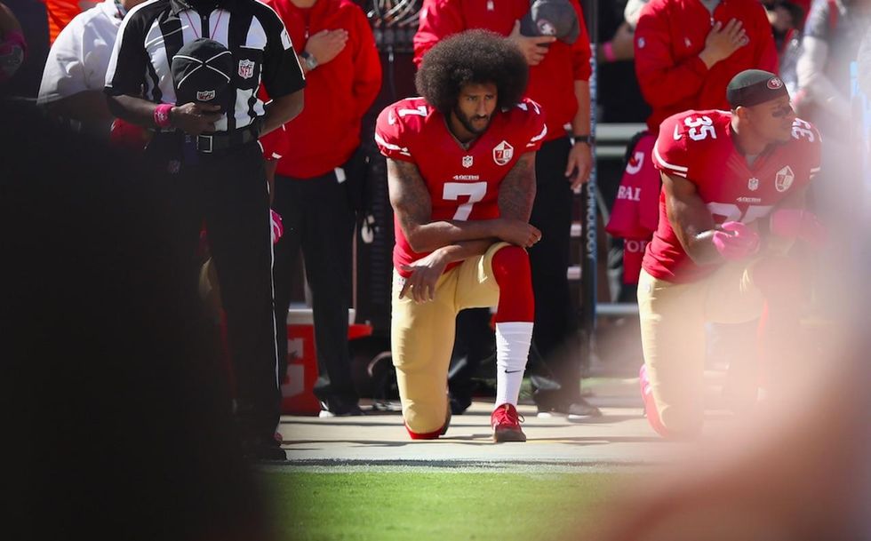 Children's book author kneels next to Colin Kaepernick cutout when reading to kids about 'whiteness