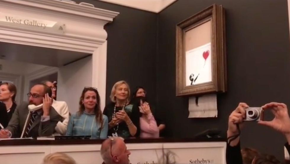 WATCH: Painting of girl with balloon sells for $1.4M. Moments later, the unthinkable happens.
