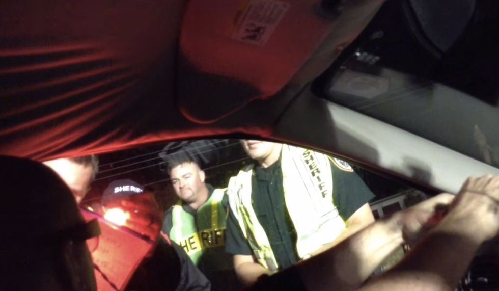See This Guy Get Through a DUI Checkpoint Without Saying a Word -- Thanks to What He Hung Out His Car Window