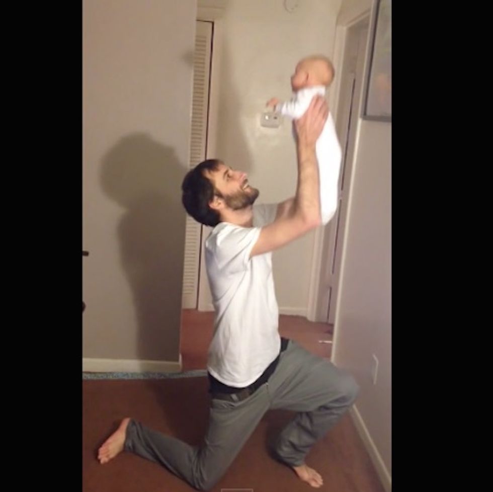 Don't try this at home: Dad holding a baby puts on his pants hands-free