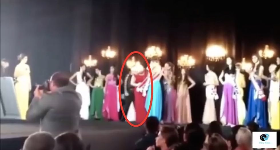 Keep Your Eye on the Woman in Red. She's About to Learn Some Major News -- and React Very Badly.