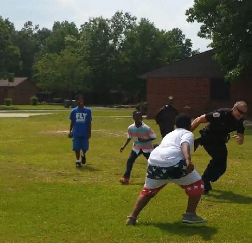 Cop Caught on Video Chasing Kids Outside Housing Project — but the Unexpected Reason Is Why the Clip Is Going Viral