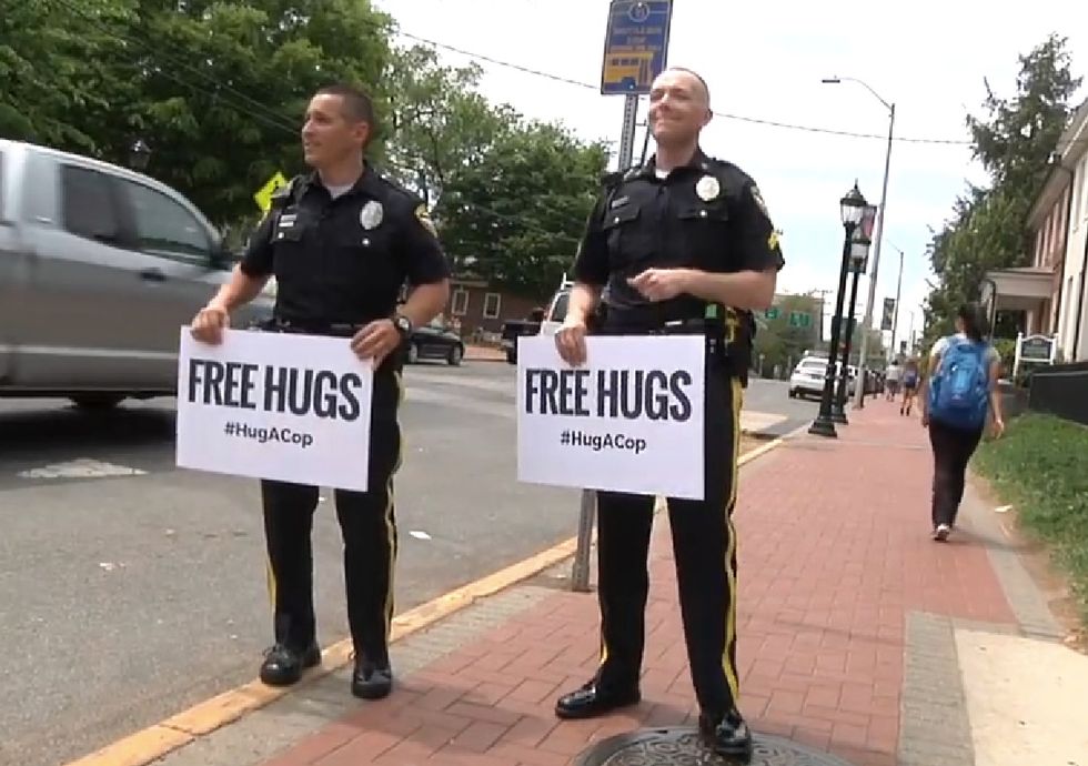 Here's What Happened When Two Cops Walked Down the Street Armed With 'Free Hugs' Signs