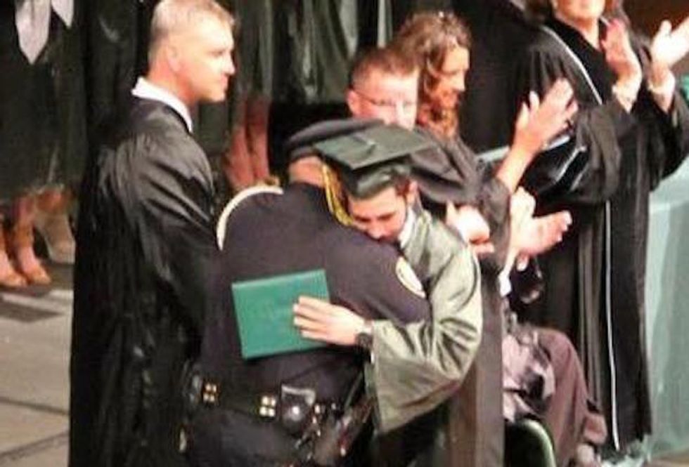 There's a Profound Reason the Auditorium Erupted as Senior Walked Across the Stage and Into the Arms of an Officer