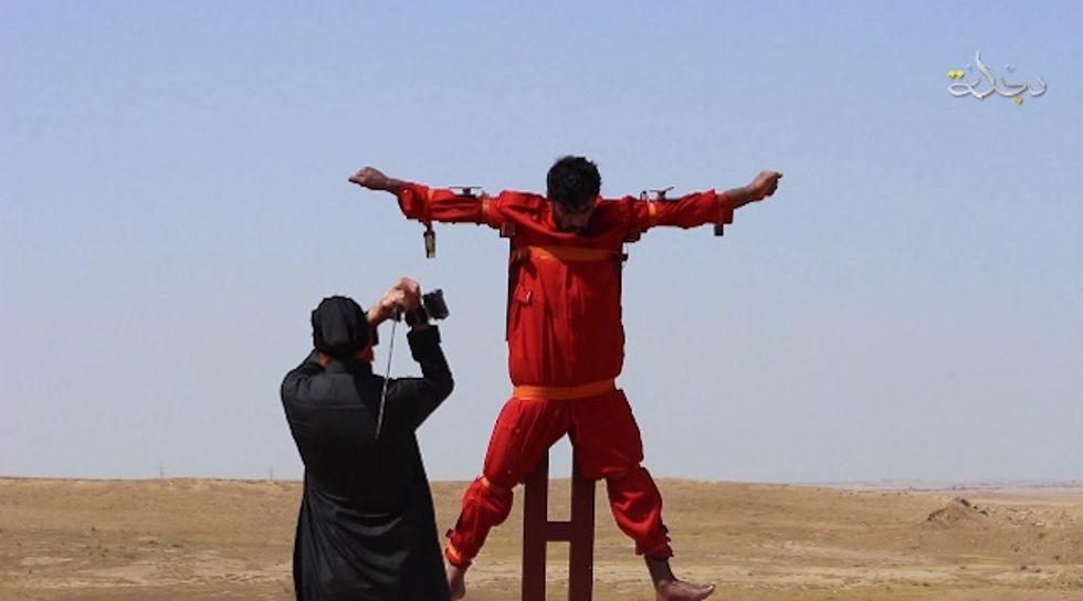 Video Purports to Show Islamic State Savagely Dismembering Man While He's Tied to a Cross