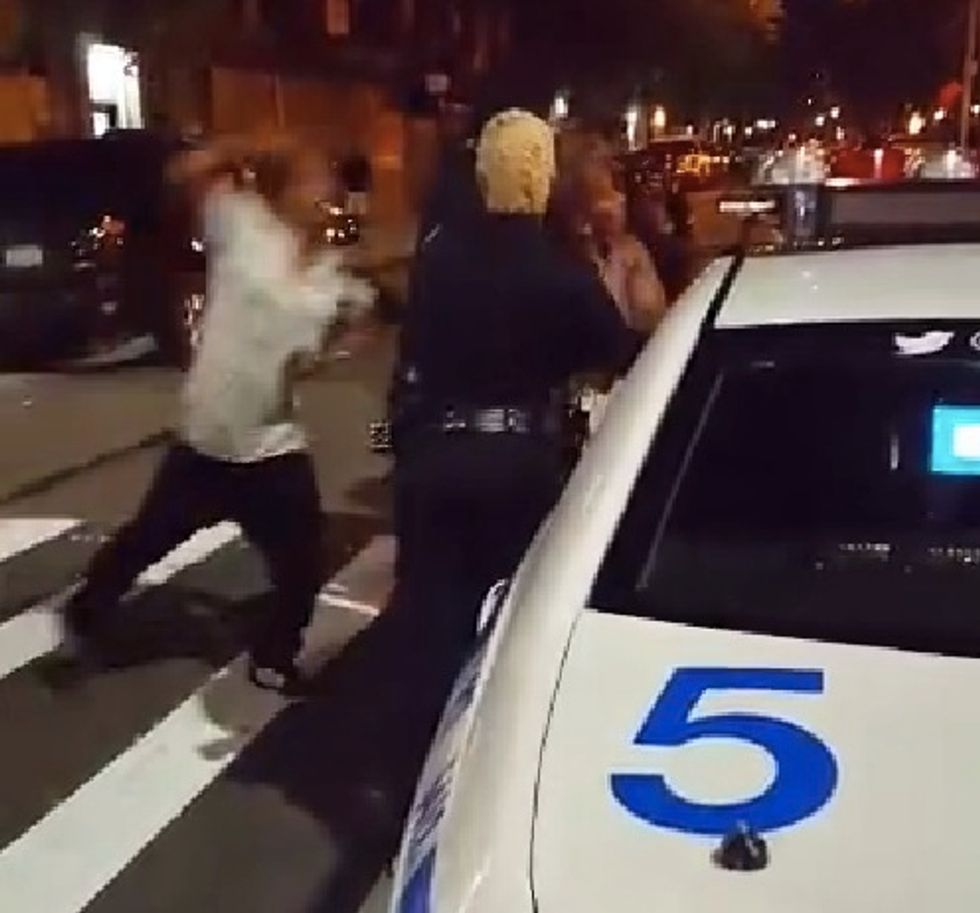 Thug Launches Multiple Punches at Pair of Surrounded NYPD Officers While Crowd Hoots and Hollers in the Street