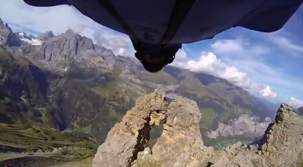 A Guy in a Wingsuit Is About to Fly Through This Narrow Rock Hole — Watch the Heart-Stopping Moment