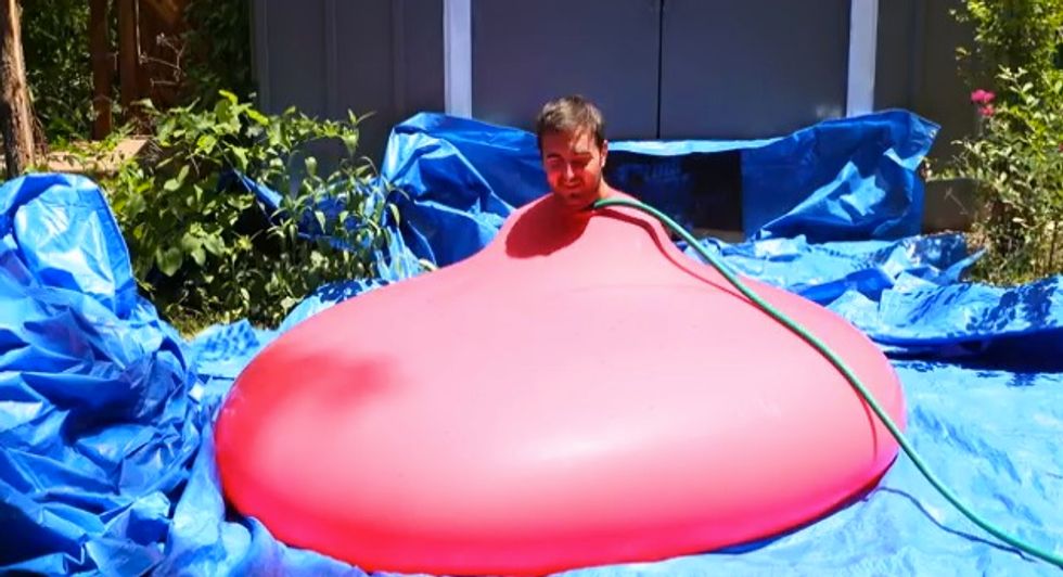 Must see moment when this six-foot water balloon with a grown man shoved inside pops