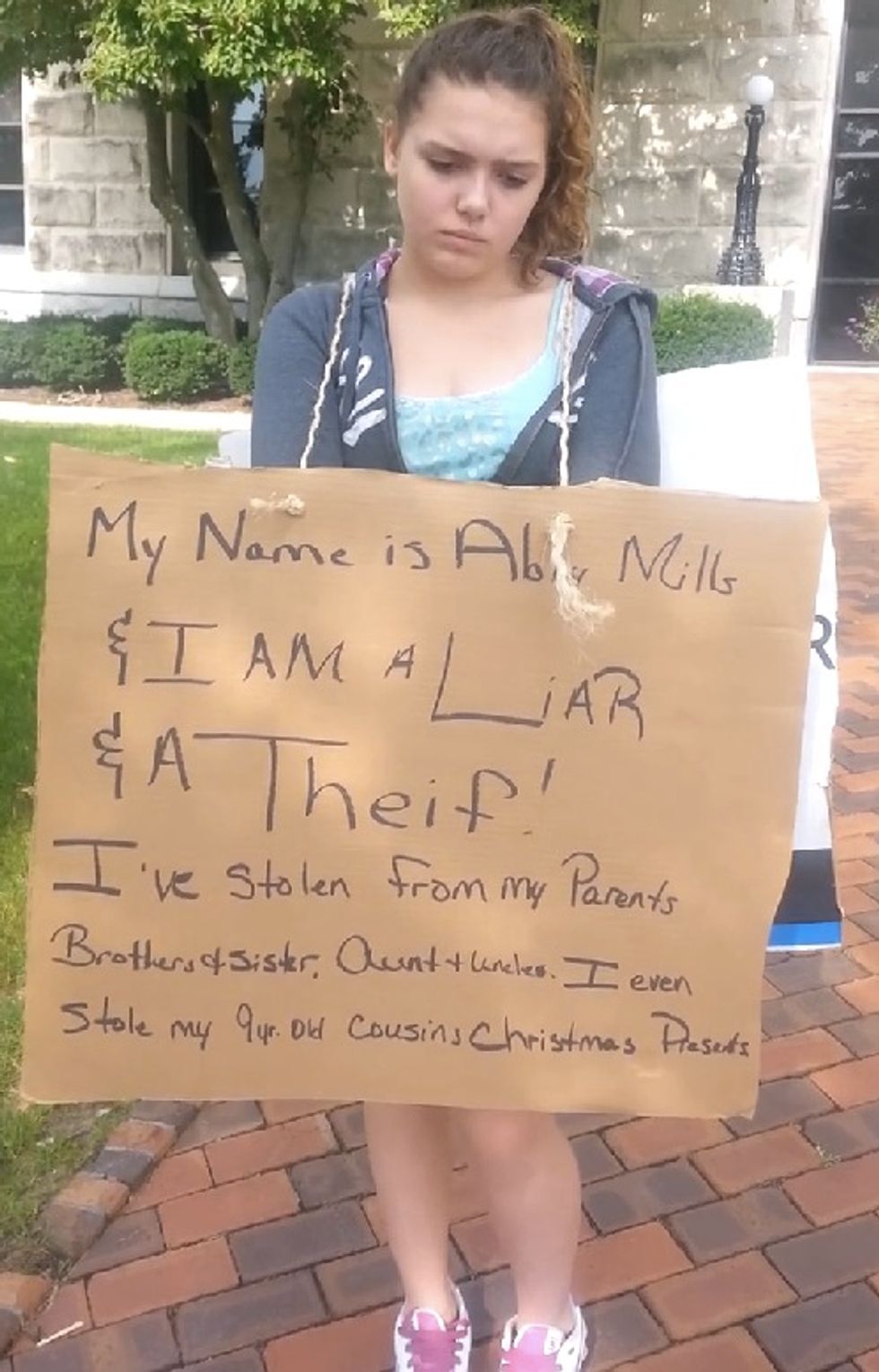 Dad Berates Teen Daughter on Camera While She Wears a Sign Announcing She's a Thief — but He Doesn't Leave Things There