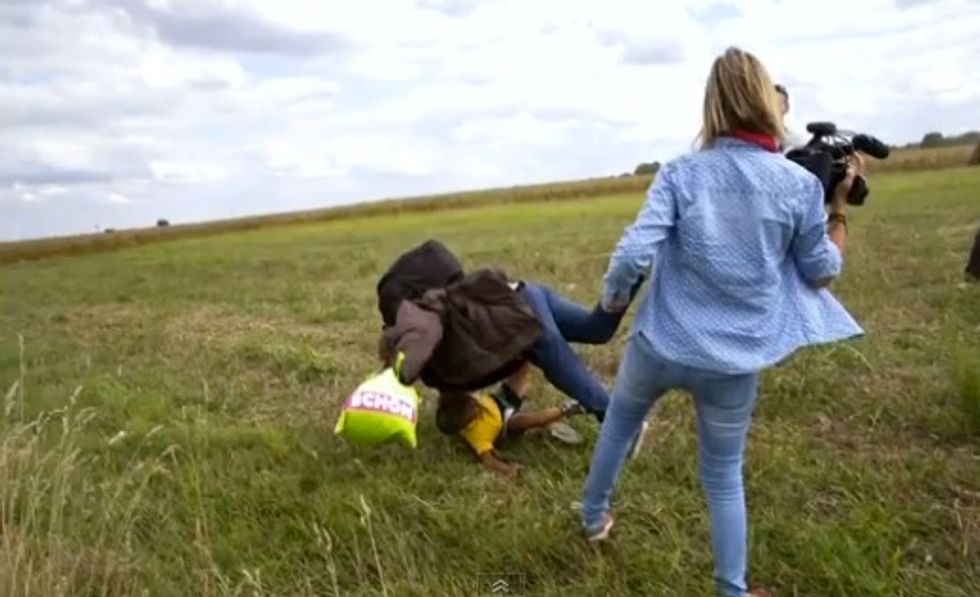 Hungarian Camerawoman Fired After She's Caught Tripping a Migrant Carrying a Child as He Was Chased by Police