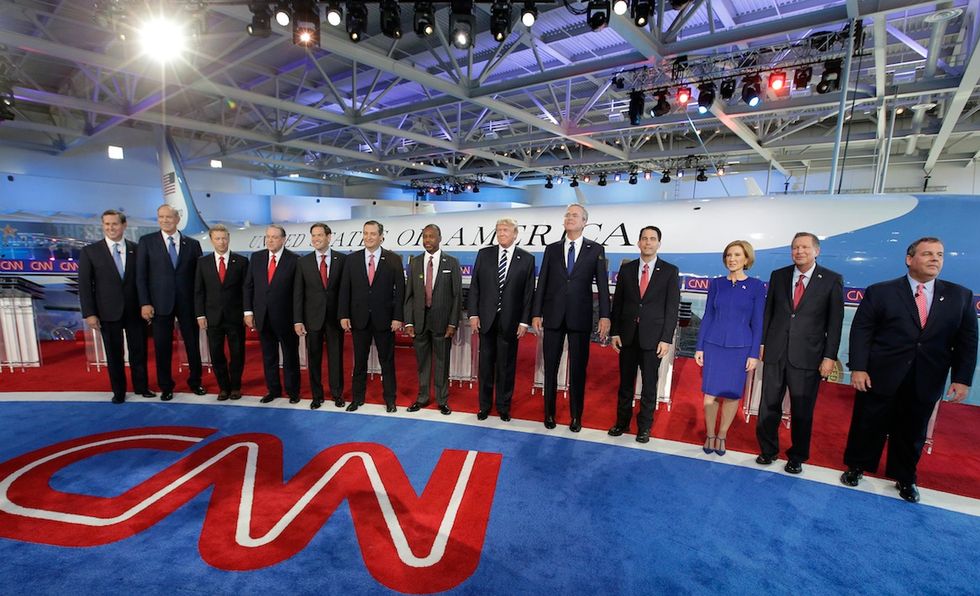 Already 6'3", This GOP Candidate Seems to Jokingly Stand on His Tiptoes During the Group Photo