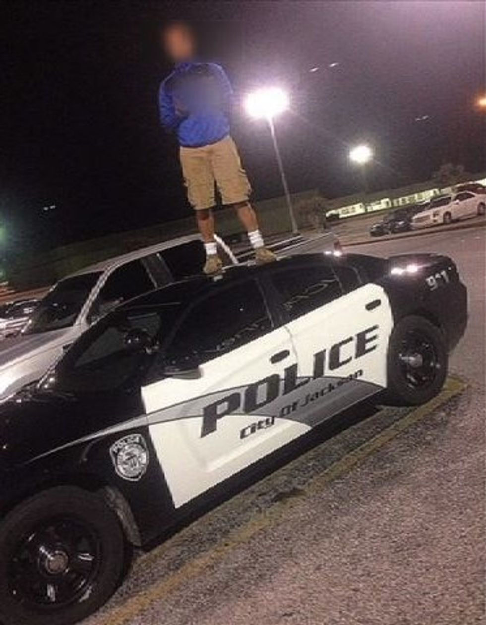 He Stood on Top of a Cop Car and Struck a Pose While Giving the Finger. He’s Probably Regretting It Now.