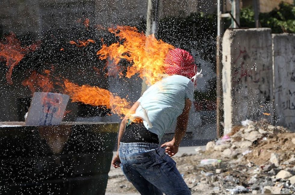 This Is a Photo of a Palestinian Who Lit Himself on Fire With a Molotov Cocktail Intended for Israeli Soldiers. Here's How Reuters Captioned the Moment.