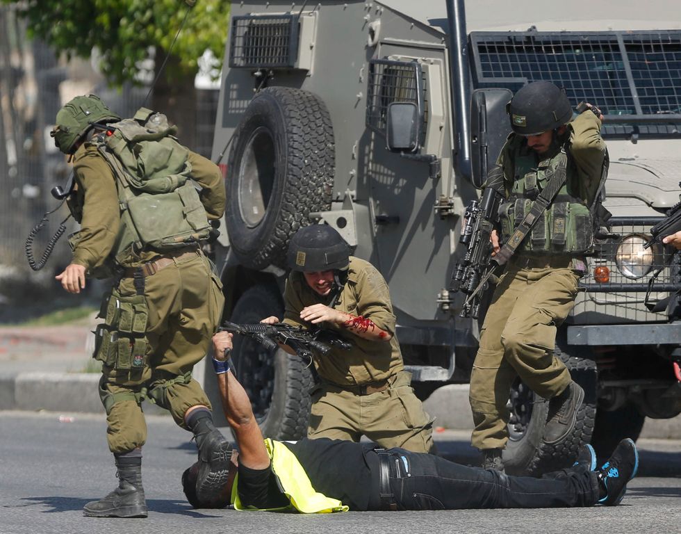 Shocking Photos Show Moments After Palestinian Man Wearing 'Press' Vest Stabbed Israeli Soldier