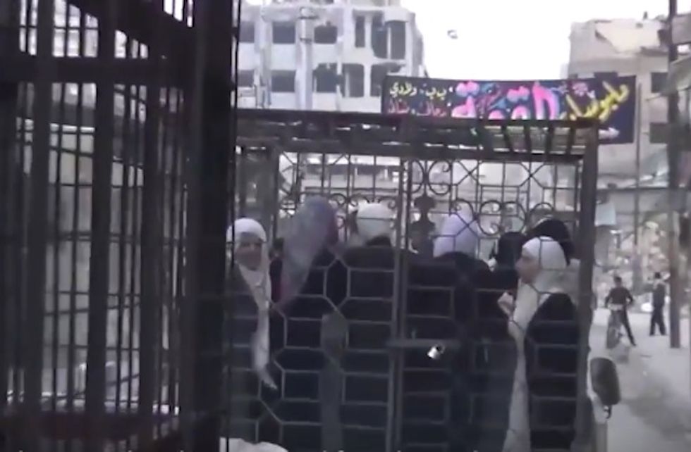 Women and Men Paraded Around Syrian Town in Cages as Human Shields Against Bombing