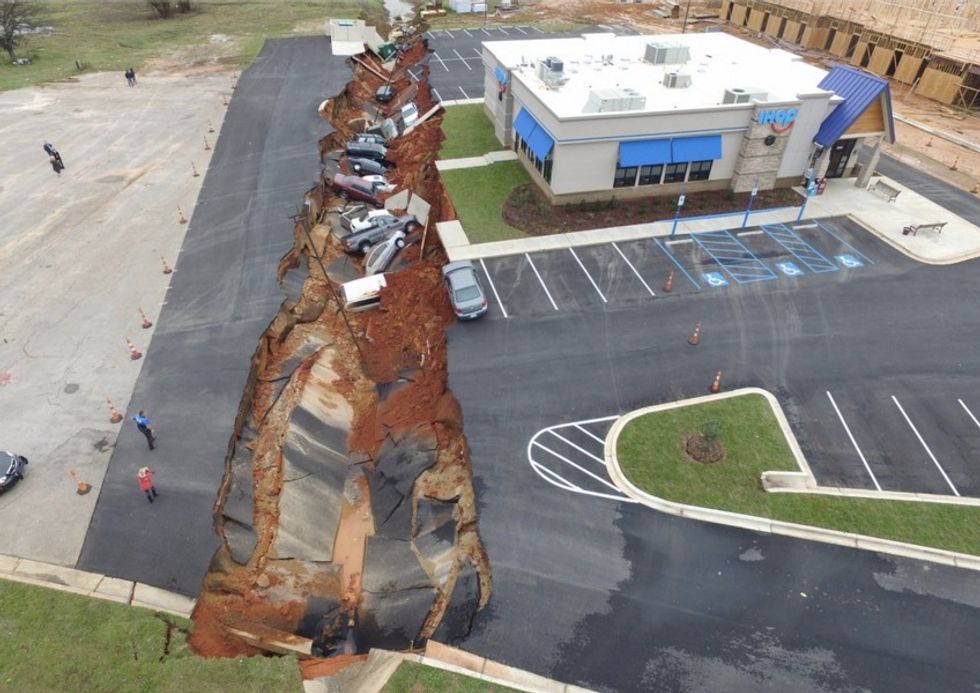 Everything Went Black and We Heard a Boom': Parking Lot Cave-In Swallows a Dozen Vehicles, Stretches 400 Feet