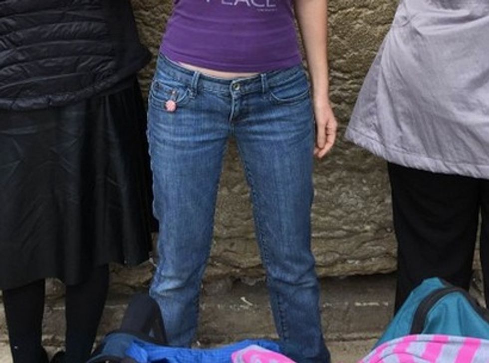 The Top This Woman Wore to a Jerusalem Holy Site Was Offensive to the Faithful — Wait Till You See the Sign She’s Holding