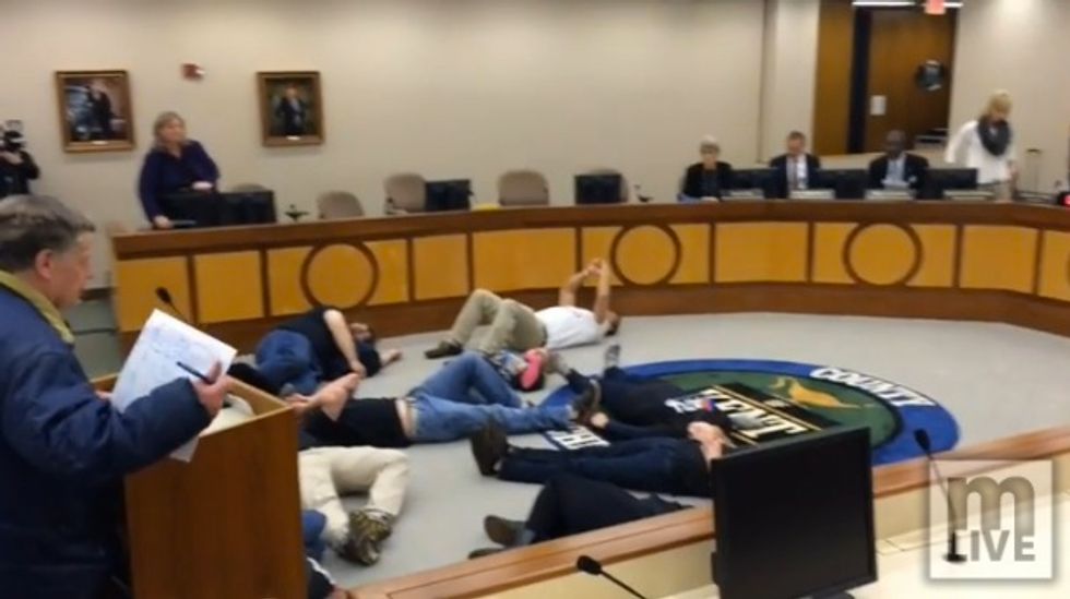 Union Protesters Shut Down City Meeting by Laying on the Ground, Chanting 'This Is What Democracy Looks Like
