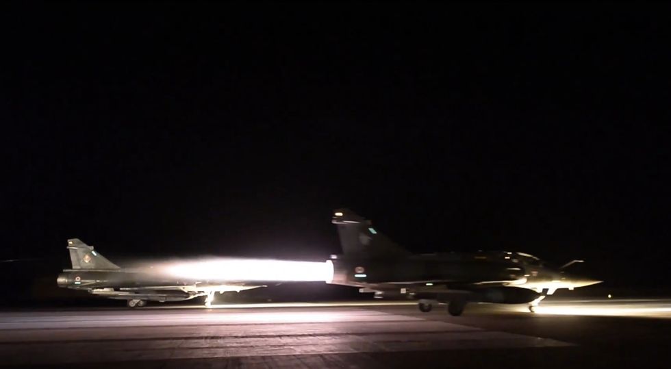 France Launches 'Massive' Air Strikes Against Islamic State HQ as Hunt Continues for More Members of Sleeper Cell That Carried Out Paris Terror Attacks
